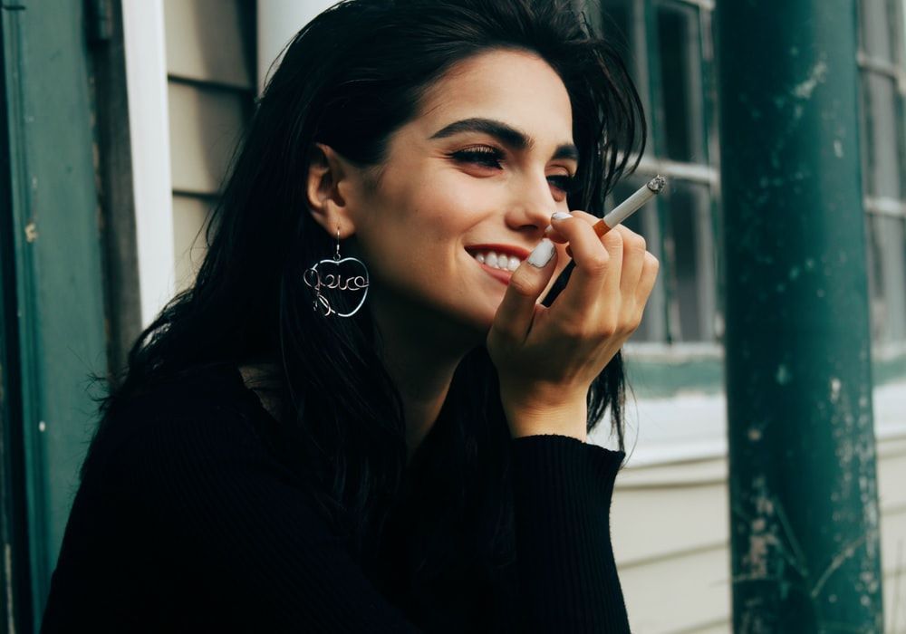 Girl smoking and smiling